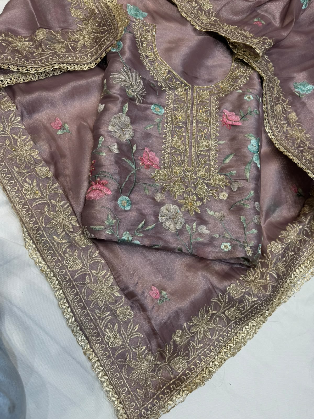 Neer Mauve satin silk with floral embroidery with gold Zari border.